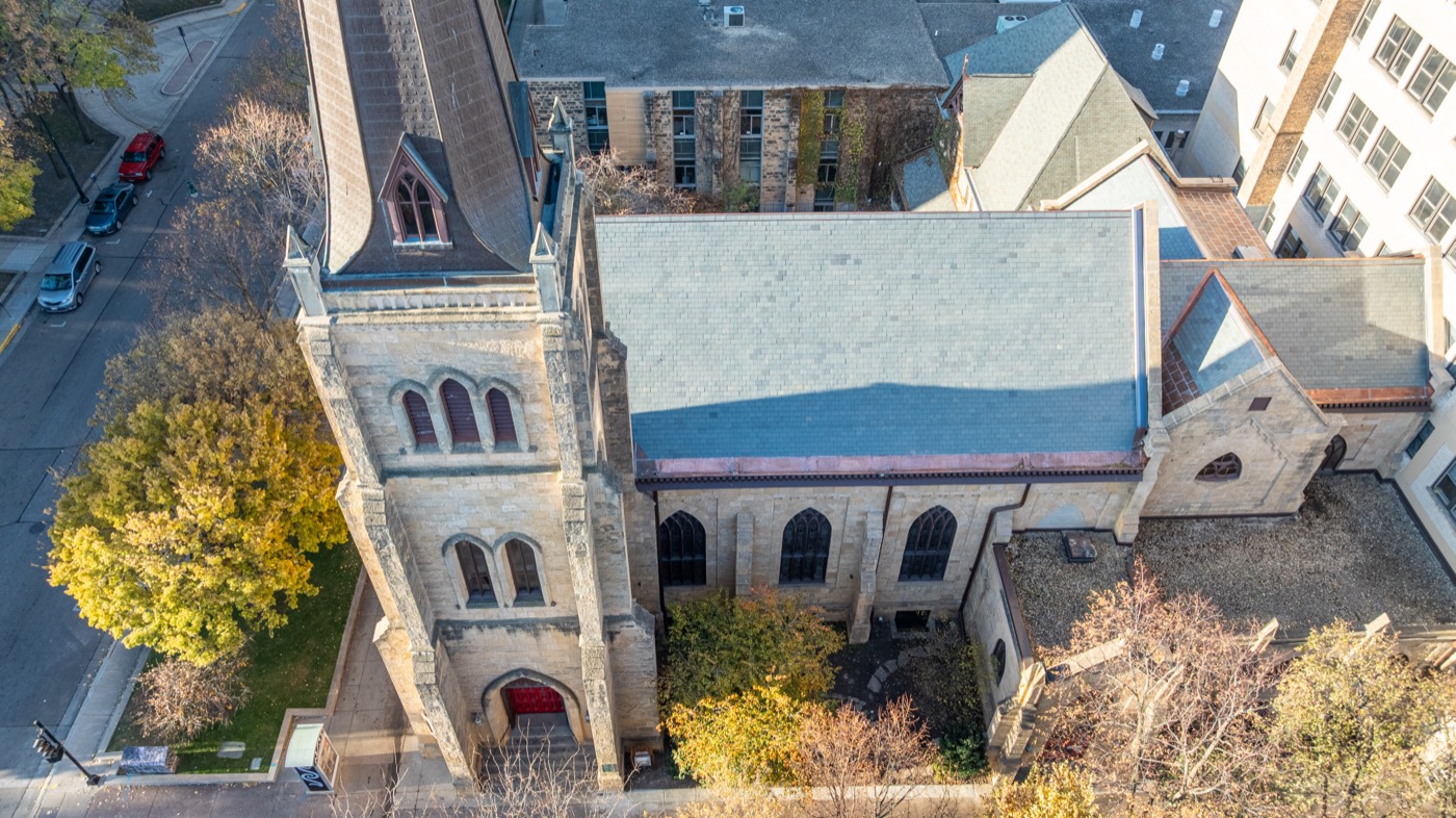 Aerial view of a historic church with a newly rehabilitated slate roof